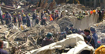 Hundreds of rescue workers and firefighters sift through the rubble of the collapsed World Trade Center. FEMA news photo by Michael Rieger.