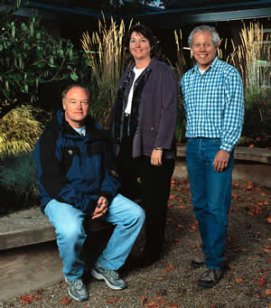 In the courtyard of the Center for Urban Horticulture are (from left) Professors H.D. Toby Bradshaw and Sara Reichard, and Center Director Rom Hinckley. Photo by Mary Levin.
