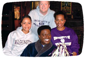 Joining the star of the Bernie Mac Show (center) are the three UW graduates who write for the show (from left): Nguyen Orange, '96; Jerry Collins, '88; and co-executive producer Kriss Turner, '84. Photo by Stephen Carmona.