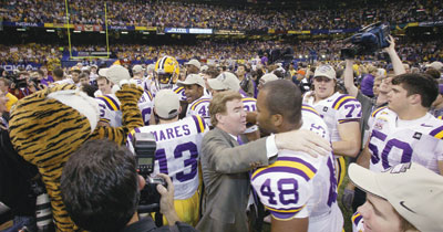 LSU Chancellor Mark Emmert congratulates as LSU football player after the Tigers' 21-14 victory over Oklahoma in the 2004 Sugar Bowl. The win clinched the national championship for LSU in the BCS rankings.