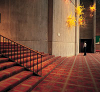 Jack Lenor Larsen's 1996 carpet in Meany Theater complements the glass sculptures by fellow UW alumnus Dale Chihuly. Photo by Claire Garoutte, © Chihuly, Inc.