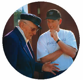 Herman Brix, '28, left discusses football with Coach Rick Neuheisel prior to the 2001 Rose Bowl. Photo courtesy Christopher Brix.