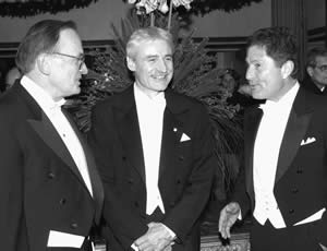 President Richard L. McCormick, right, congratulates UW Genome Sciences Professor Lee Hartwell, center, at a banquet for winners of the Nobel Prize in Stockholm, Sweden. At the left is Shan Mullin, chair of the Fred Hutchinson Cancer Research Center Board of Trustees. Hartwell is also president and director of the cancer center. Photo by Ecke Kuller.