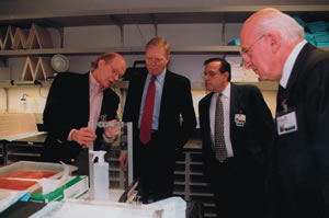 Genetics pioneer Robert Waterston (left) explained some sequencing equipment to Rep. Richard Gephardt, former Democratic leader in the U.S. House of Representatives, when Gephardt visited Waterston's lab in St. Louis. Photo courtesy of Washington University in St. Louis.