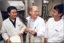 Bob Waterston jokes with two research assistants. Photo courtesy Washington University in St. Louis.