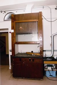 A 1930 wooden fume hood with asbestos lining sits in a Johnson Hall lab. Photo by Kathy Sauber.