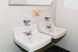 A sign warns users that laboratory water has contaminated the supply of potable water in this Johnson Hall bathroom. Photo by Kathy Sauber.