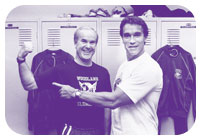 Former Washington Gov. Booth Gardner, '58, shows his might to Arnold Schwarzenegger during the actor-bodybuilder's visit to the UW campus July 21, 1990. Photo by Davis Feeman.