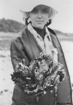 Landolt holds a cluster of oyster shells in this 1976 photo taken at Rocky Bay on Puget Sound. Photo by Ken Chew.