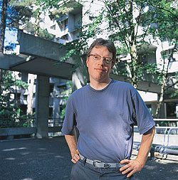 Charles R. Cross, '81, stands in front of McMahon Hall, one of the newer residence halls on the UW campus. Photo by Kathy Sauber.