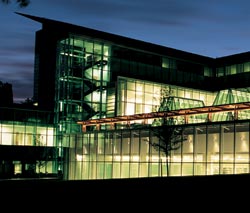 Glass walls and skylights allow William Gates Hall to look dazzling at night when the lights are on. Photo by Kathy Sauber.