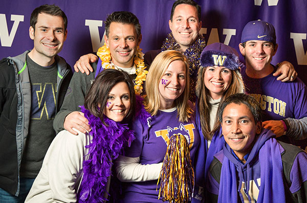A group of UW fans wearing purple.