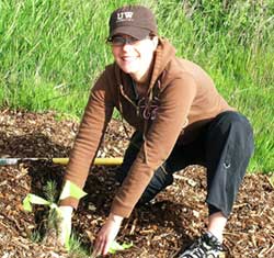 FRAA President Ara Erickson plants a tree