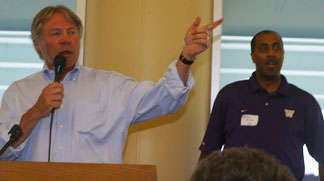 MC Bob Rondeau, left, and men's basketball Coach Lorenzo Romar