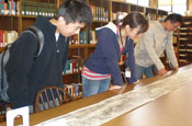 Students examine the scroll