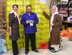 Farzaneh Zahraie, left, a postal employee and Mary St. Germain finalize shipment of the books and CDs to UW Libraries.