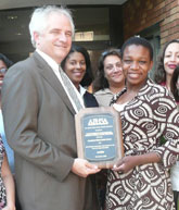 Mark Courtney, Zynovia Hetherington & staffs with award