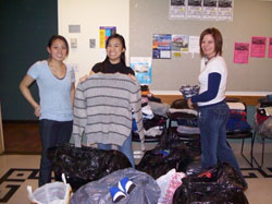 Sandy, Alisa & Ruby surrounded by donations