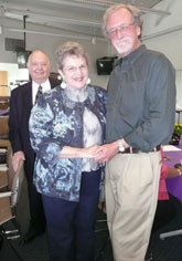 Ruth Huber with Roger Roffman, her former professor; in back husband Don looks on.