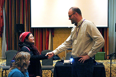 A panelist shakes hands with AccessComputing Co-PI Jacob Wobbrock.