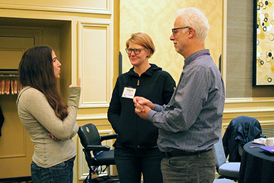 Participants stand and talk with AccessComputing PI Richard Ladner.