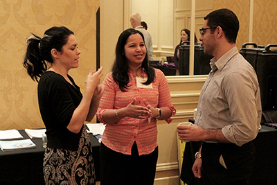 Participants talk at a conference using an interpreter.