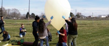 A group prepares to launch a high-altitude balloon at a recent event. Similar balloons were launched right before the Aug. 21 eclipse began.