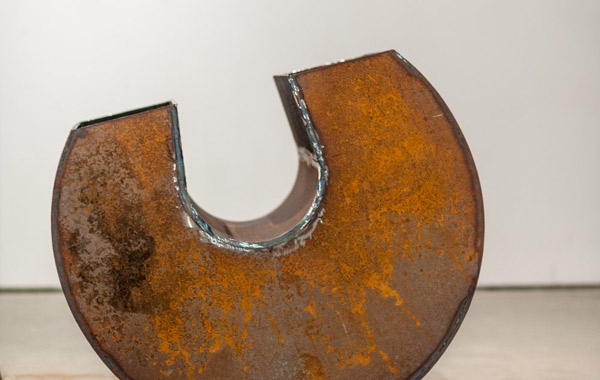 Horseshoe-shaped rusty sculpture