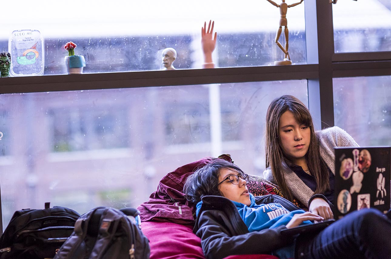 Sophia Mallouk, a member of the DFL’s audio and music composition team, shares the lab’s giant red beanbag chair — and a laptop — with artist Rena Chen