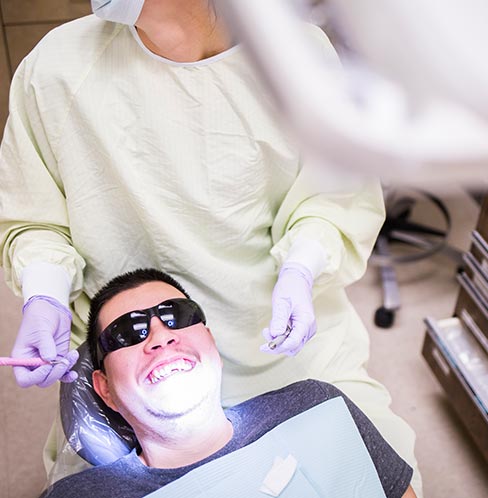 DECOD clinic patient Ruben Santana shares a laugh with dental student Meg Hurd. DECOD care providers talk through each step of the process with patients, and give them breaks as needed.