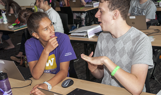 Two students who have hearing impairments discuss a computing project