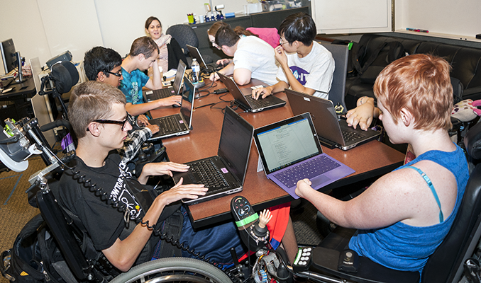 A diverse group of students working on individual computing projects