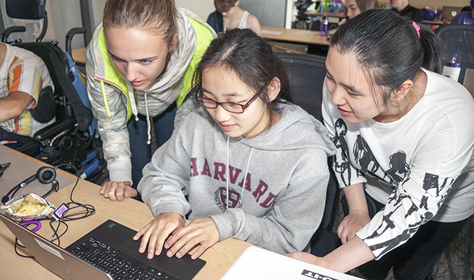 Three students work on a computing project together