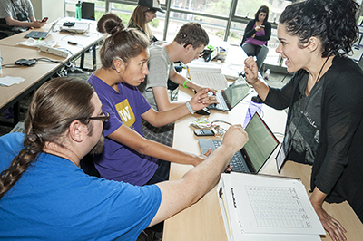 Students and instructors work together on computers.