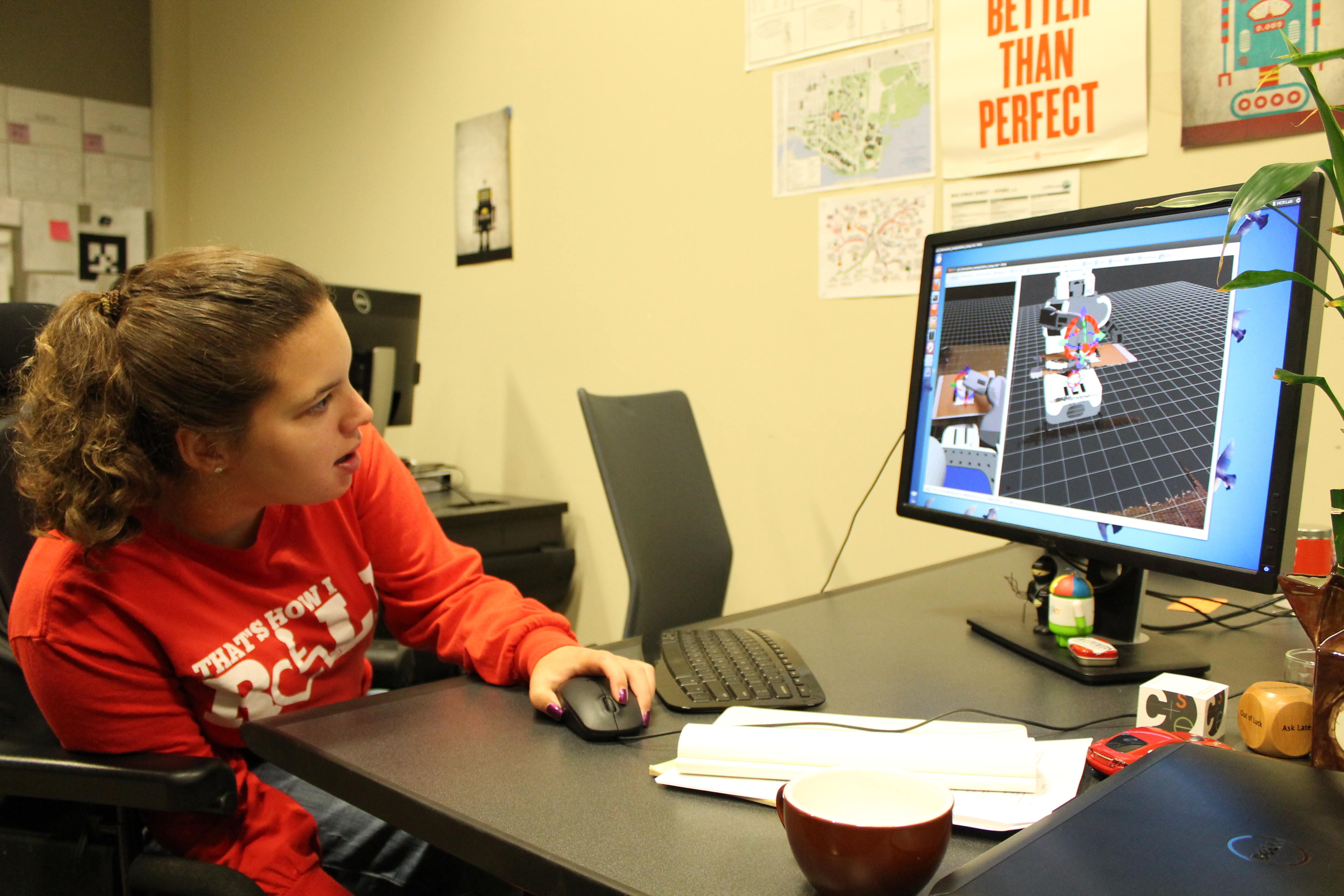 A student sitting in a wheelchair uses a computer