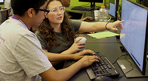 A student and educator work on a quorum project together.