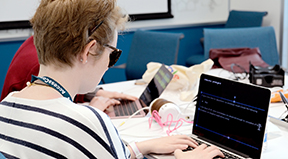 A student with a visual disability codes on a computer during last year's OurCS workshop.