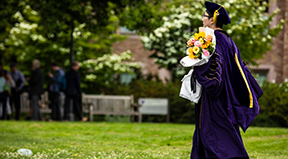 A PhD graduate walks to their ceremony.