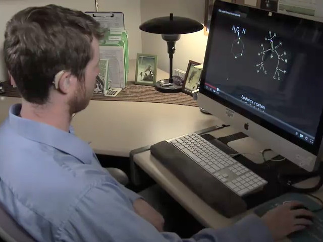 
Still image from video: A deaf student watches a video with captions