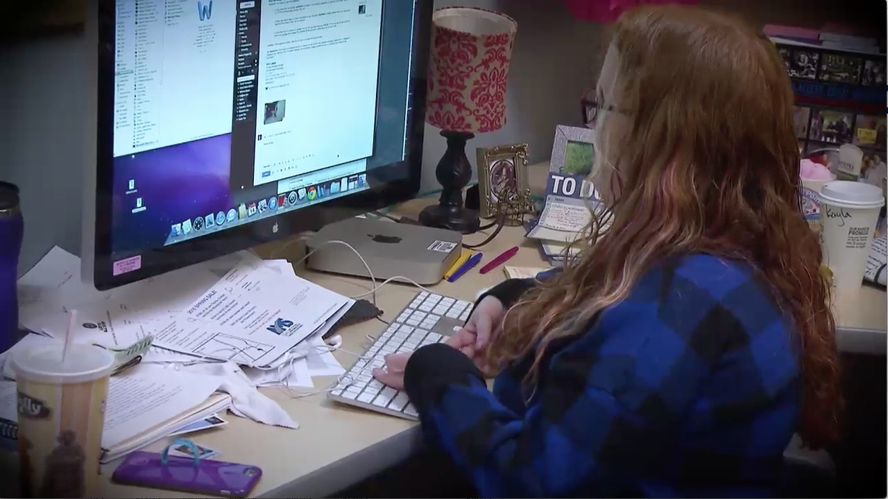 
A graduate student types on a computer.