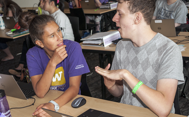 Two students who have hearing impairments discuss a computing project Two students who have hearing impairments discuss a computing project