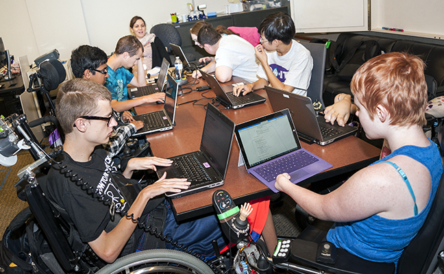 A diverse group of students working on individual computing projects A diverse group of students working on individual computing projects
