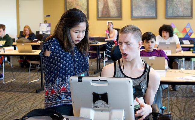 Two students with disabilities work together on the computer. Two students with disabilities work together on the computer.
