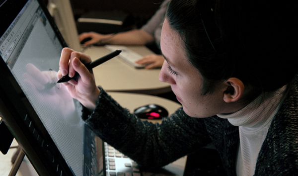 A student uses a stylus to work on a computing project