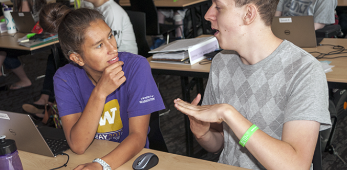 Two students who have hearing impairments discuss a computing project