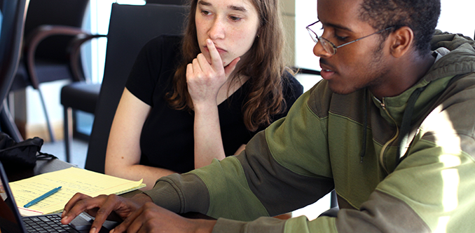 Two students collaborate on a computing project