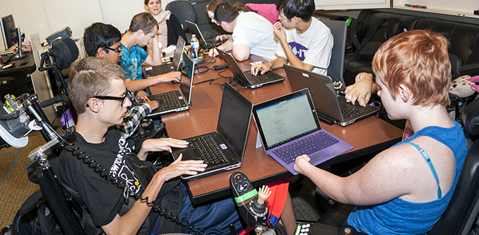 A diverse group of students working on individual computing projects