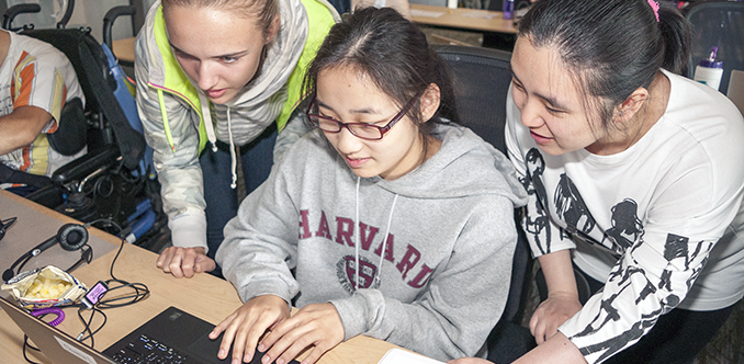 Three students work on a computing project together