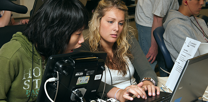 Two students use assistive technology to work on a computing project Two students use assistive technology to work on a computing project