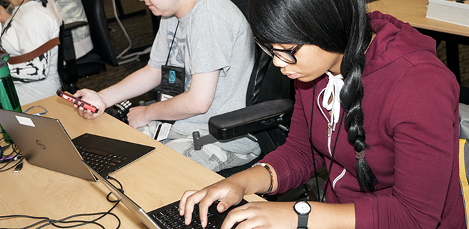 Two students working in a computer lab Two students working in a computer lab